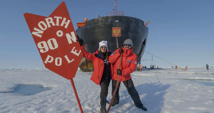 Пассажиры фотографируются на фоне ледокола